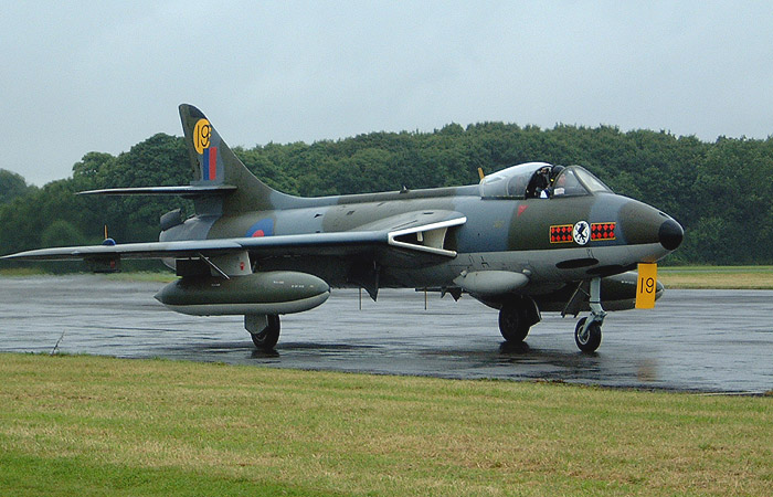 Having just flown in from CJAC's home base at Exeter, Peter Helliers F6A XF516/G-BVVC taxies in following a heavy rain shower during Saturday afternoon to join the Hunter line for the following days display.